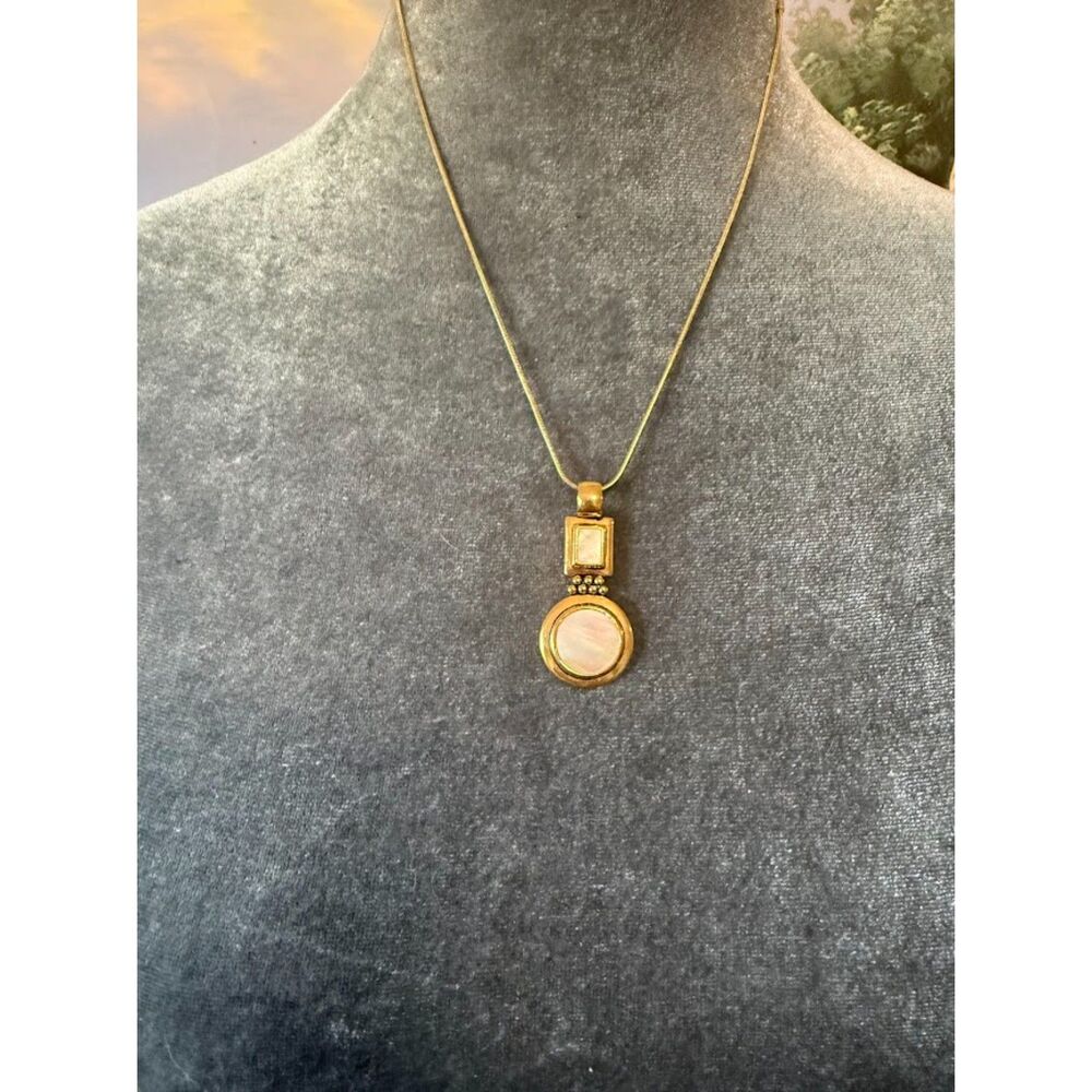 🌴Lia Sophia, featuring a round pendant with white accents.